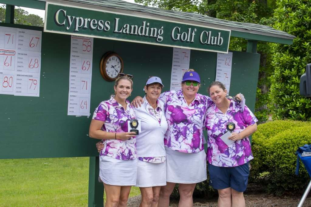 Four women in front of sign reading Cypress Landing Golf Club