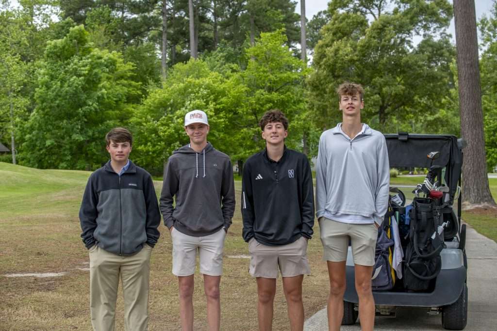 Four people with a golf cart