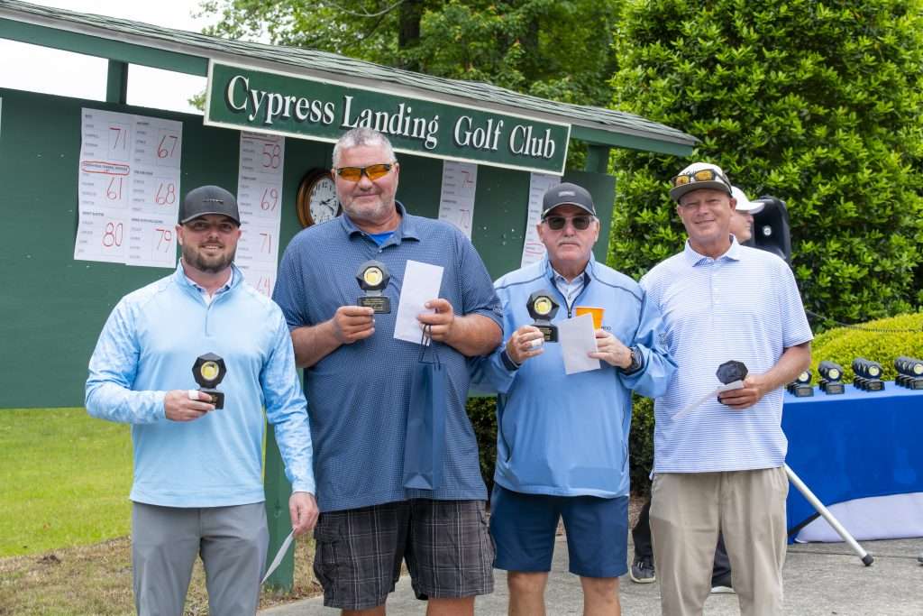 Four men in front of sign reading Cypress Landing Golf Club