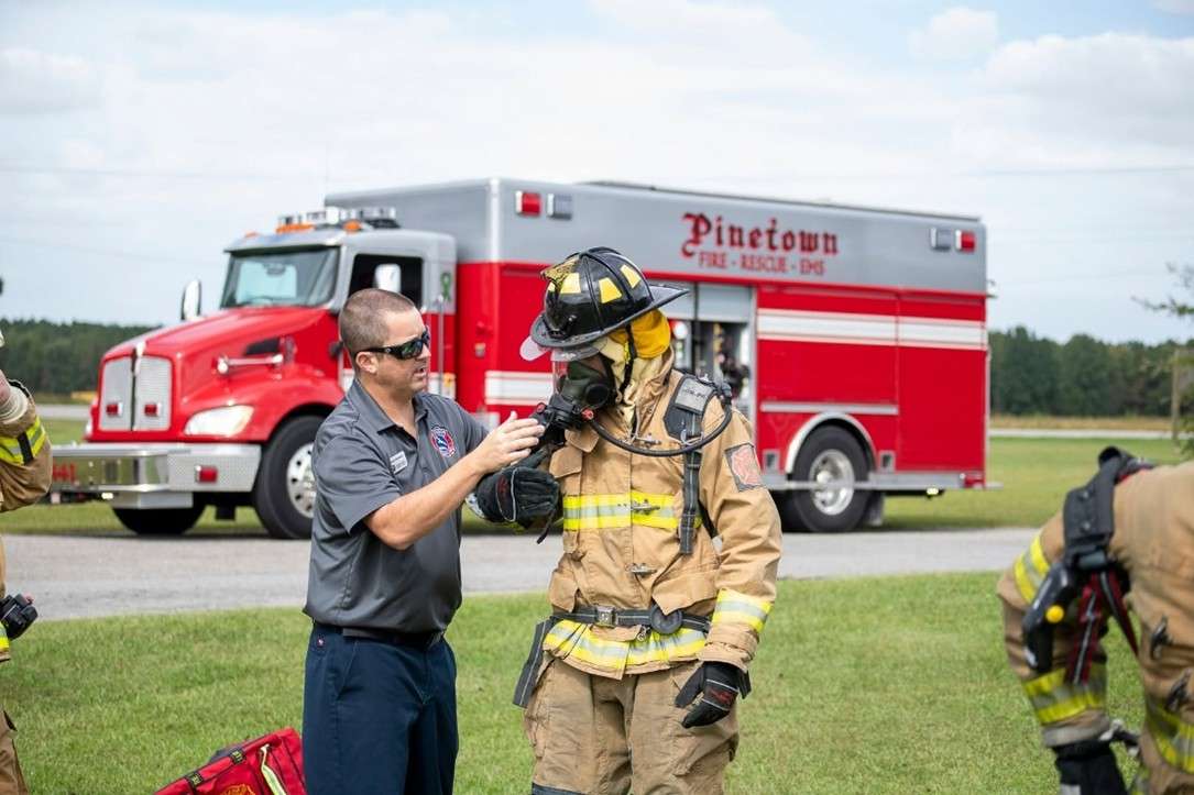 Firefighters in front of a fire truck