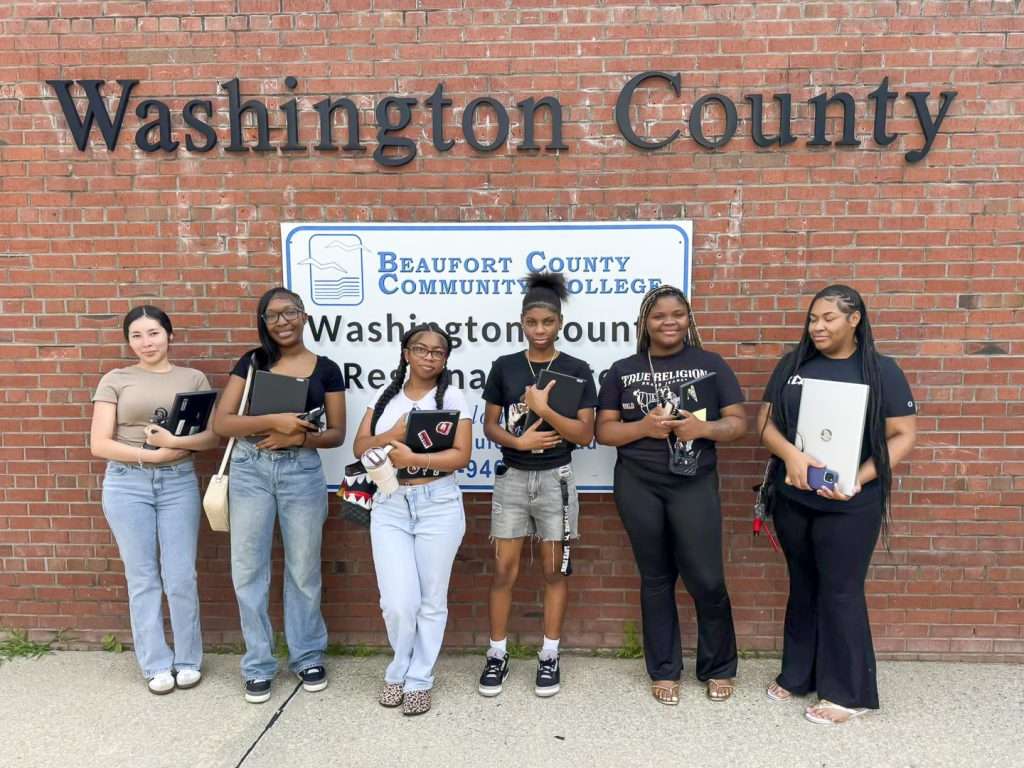 Group of students in front of sign reading Washington County