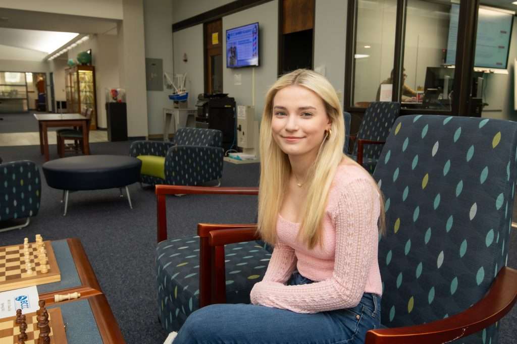 Woman sitting in chair.