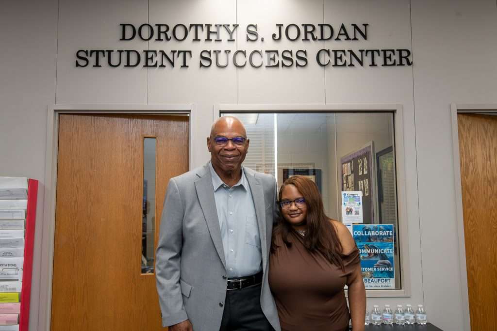 Michael Jordan and Tatum Jordan standing beneath the Dorothy S. Jordan Student Success Center sign at Beaufort County Community College